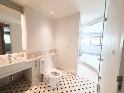 Modern bathroom with stylish tile flooring and glass shower enclosure