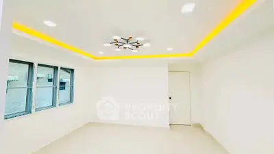 Bright modern room with stylish ceiling lights and large windows