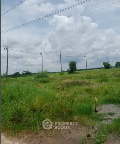 Expansive green land with clear skies, perfect for development opportunities.