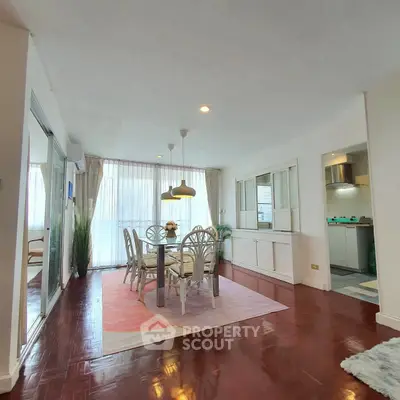 Spacious living room with elegant dining area and natural light