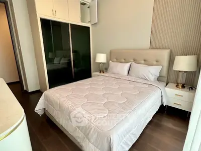 Modern bedroom with elegant decor and ample storage in a stylish apartment.
