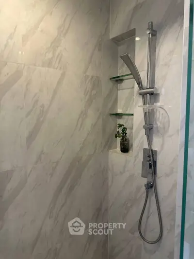 Modern bathroom with sleek shower fixtures and marble tiles