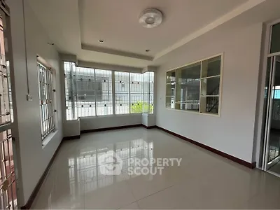 Spacious corner unit with large windows and glossy tiled floors, perfect for natural light and modern living.