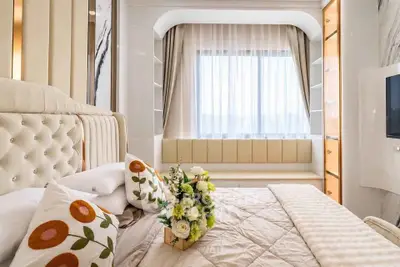 Luxurious bedroom with elegant decor and large window seating area