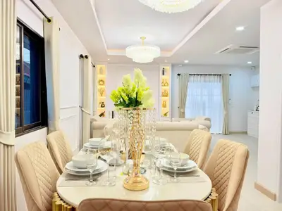 Luxurious dining area with elegant decor and modern lighting in a stylish open-plan living space.