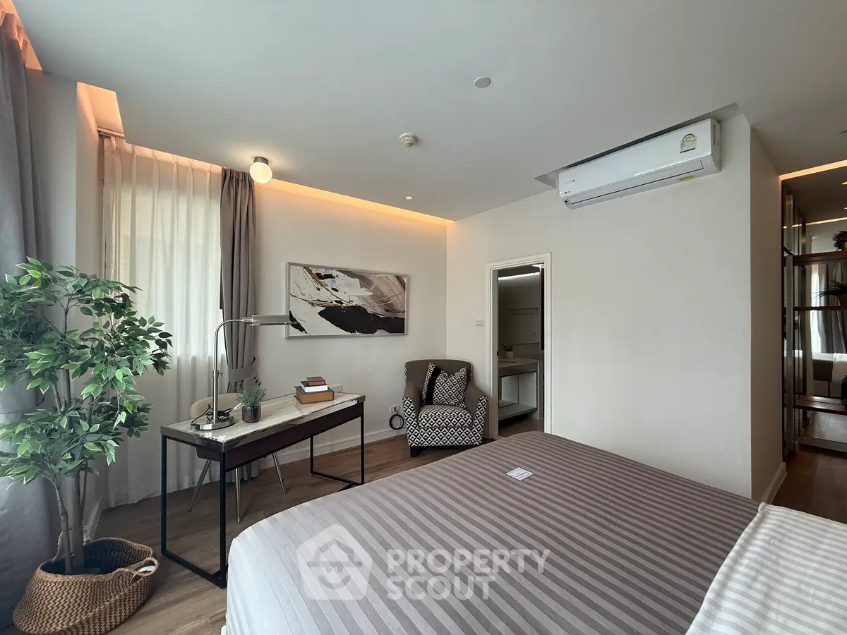 Modern bedroom with stylish decor, featuring a cozy bed, study desk, and elegant lighting, perfect for relaxation.