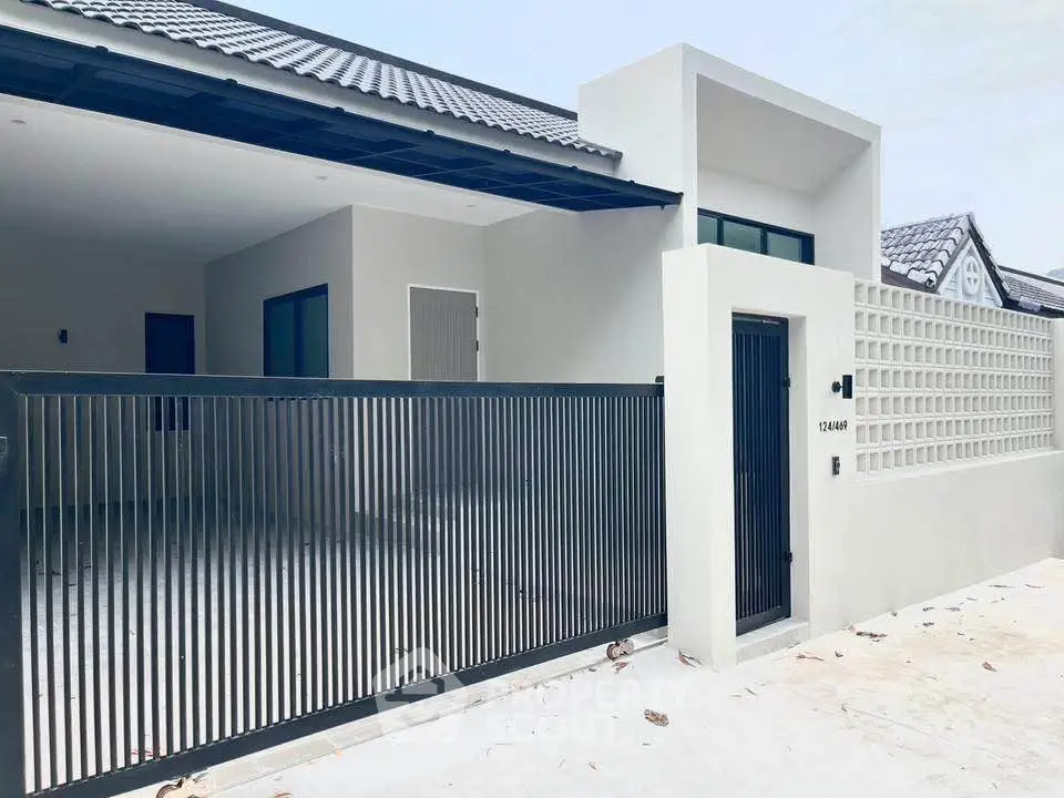 Modern minimalist house exterior with sleek gate and clean lines