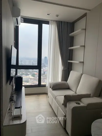 Cozy living room with city view, modern sofa, and large window in high-rise apartment.