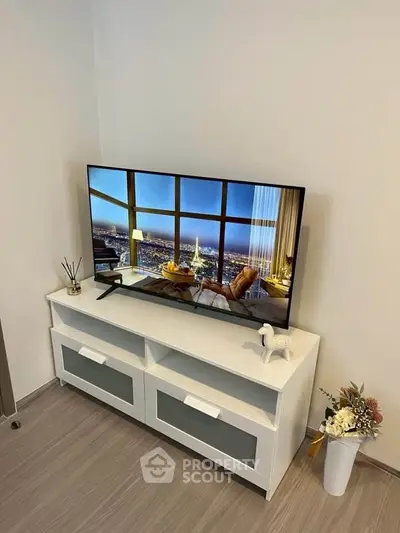 Modern living room with sleek TV stand and decorative elements, perfect for cozy evenings.