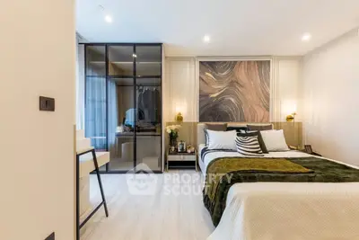 Luxurious modern bedroom with stylish decor and glass wardrobe, perfect for comfort and elegance.