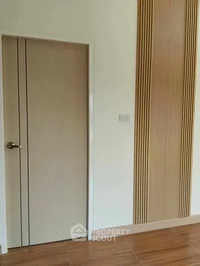 Modern interior with wooden door and stylish wall paneling