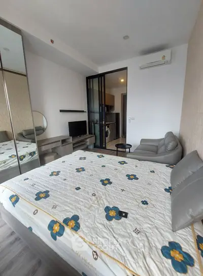 Modern bedroom with stylish decor and mirrored wardrobe in a cozy apartment.