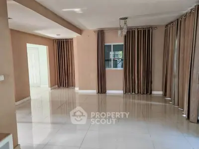 Spacious empty living room with elegant curtains and glossy tiled flooring