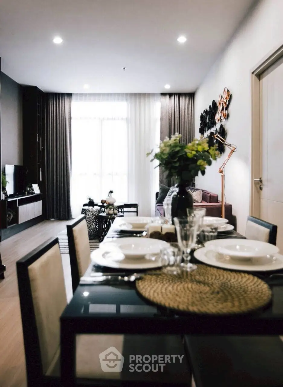 Modern dining area with elegant table setting and cozy living room view