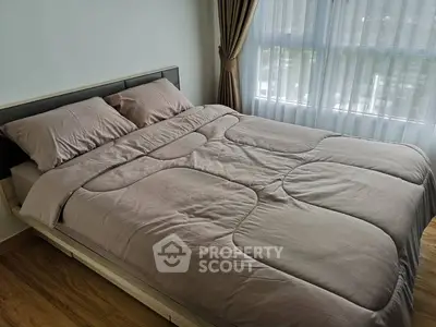 Cozy bedroom with large window and elegant curtains