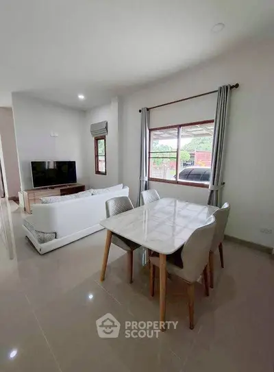 Modern living room with dining area and large window view