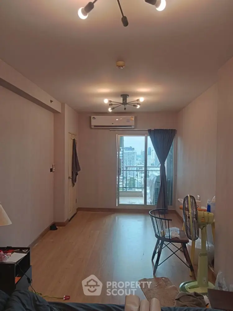 Spacious living room with city view and balcony access in modern apartment