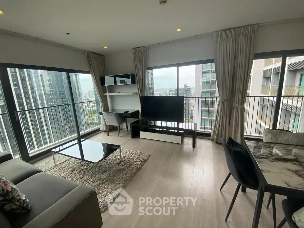 Spacious modern living room with panoramic city views and elegant furnishings.