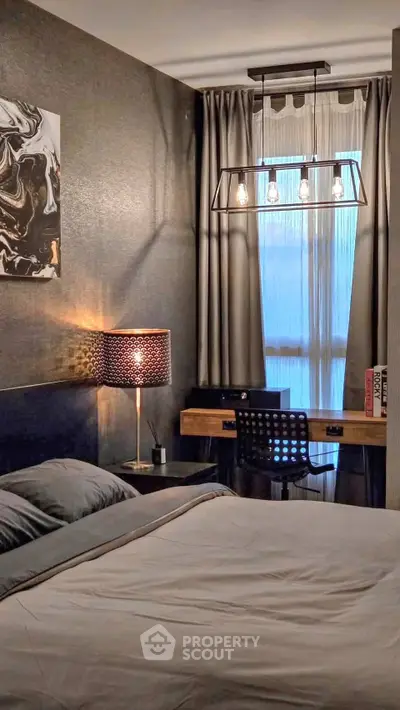 Modern bedroom with stylish decor and workspace, featuring elegant lighting and cozy ambiance.