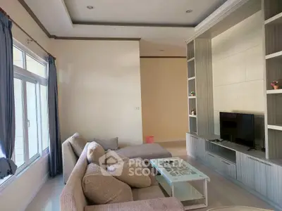 Spacious living room with modern entertainment center and cozy seating