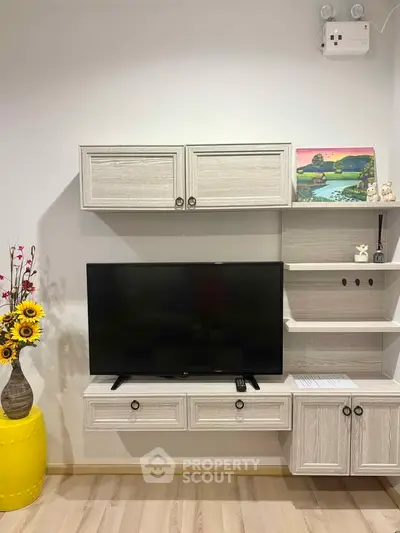 Modern living room with stylish TV unit and decorative elements, perfect for cozy home entertainment.