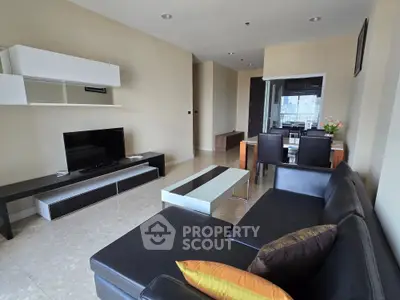Spacious modern living room with sleek furniture and city view, perfect for urban living.