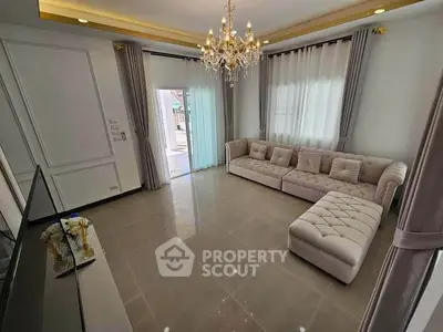 Elegant living room with chandelier and plush sectional sofa