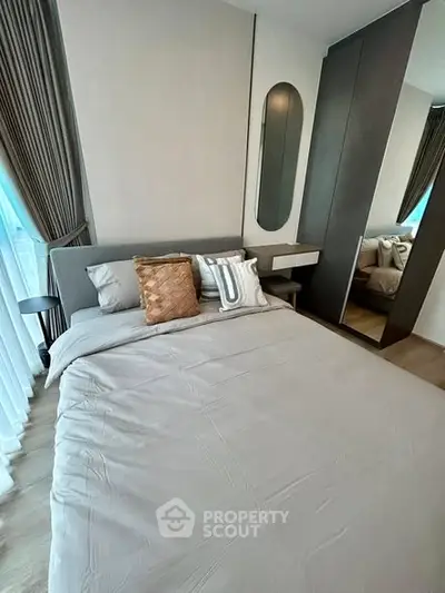 Modern bedroom with stylish decor and ample natural light