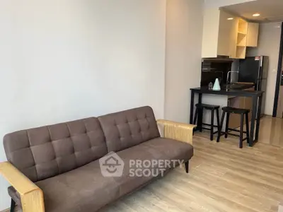 Modern living room with stylish sofa and open kitchen layout