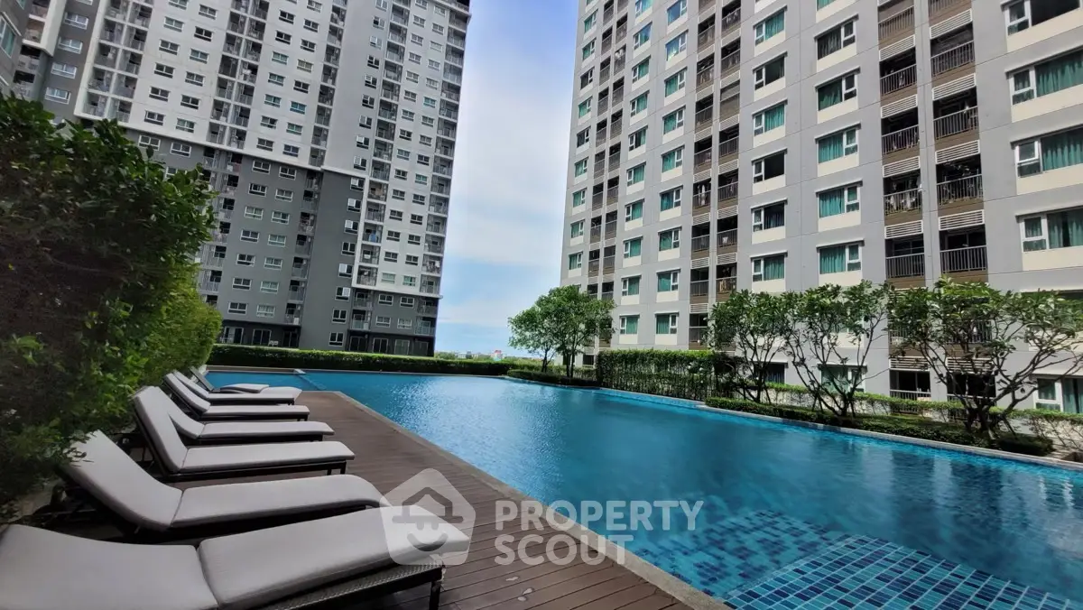 Luxurious apartment complex with a stunning pool and modern architecture.