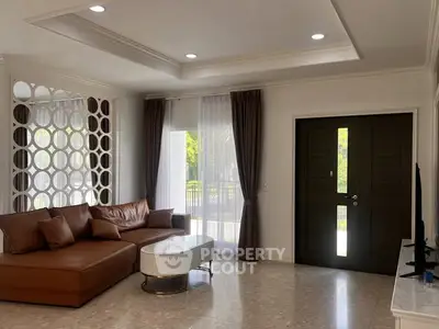 Spacious living room with modern decor and large windows for natural light.