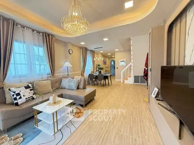 Luxurious living room with elegant chandelier and modern decor in a spacious open layout.