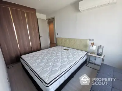 Modern bedroom with stylish decor and air conditioning in a contemporary apartment.