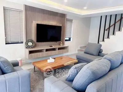Modern living room with stylish furniture and wall-mounted TV