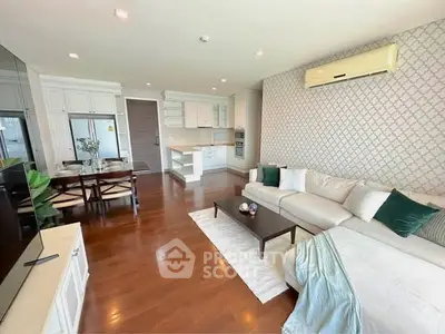 Spacious living room with elegant decor and open kitchen layout in modern apartment.