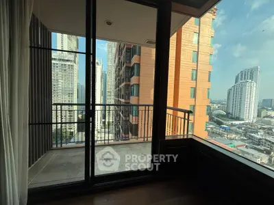 Spacious balcony with stunning cityscape views in a modern high-rise apartment.