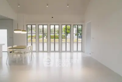 Spacious modern living room with large windows and minimalist decor