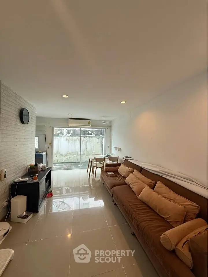 Spacious living room with modern decor and large windows offering natural light.