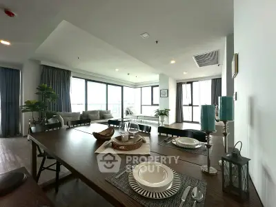 Spacious modern living room with elegant dining area and large windows.