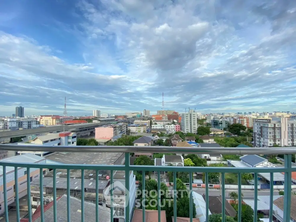 Stunning cityscape view from high-rise balcony with expansive skyline and vibrant urban landscape.