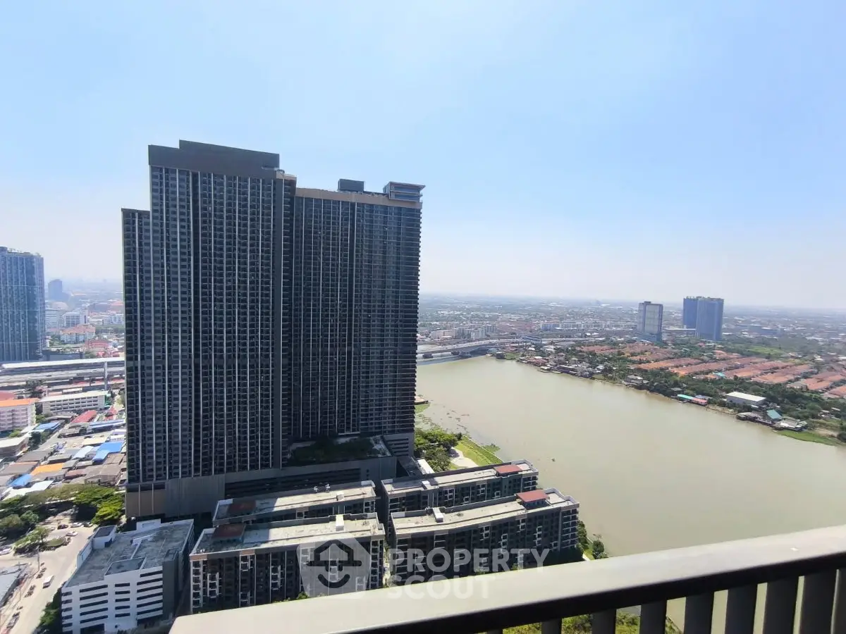 Stunning high-rise building with panoramic river view and cityscape.