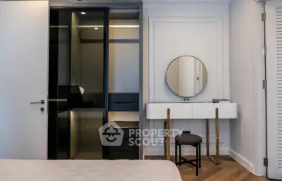 Modern bedroom with sleek wardrobe and stylish vanity mirror