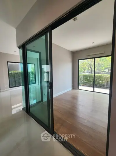 Spacious modern living area with sliding glass doors and garden view.