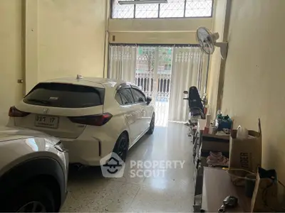Spacious garage with two cars and ample storage space in a residential property.