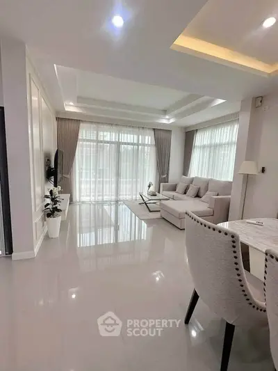 Spacious modern living room with elegant decor and large windows for natural light.