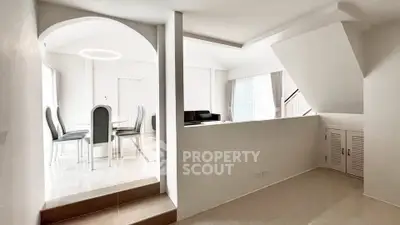 Modern open-plan living and dining area with sleek design and natural light.