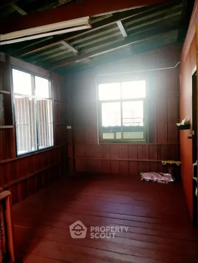 Charming rustic interior with wooden walls and flooring, perfect for cozy living.
