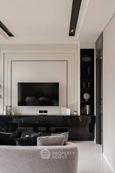 Luxurious modern living room with sleek black marble accents and wall-mounted TV, perfect for stylish urban living.