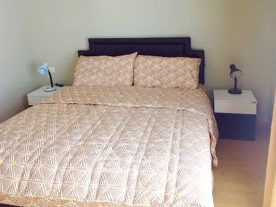 Cozy bedroom with stylish bedding and modern bedside lamps