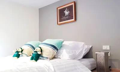 Cozy bedroom with stylish decor and plush bedding, perfect for relaxation.